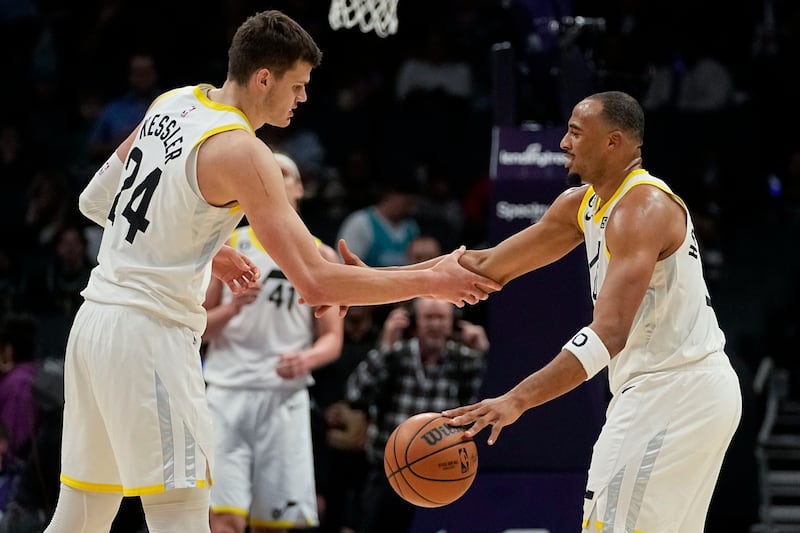Utah Jazz guard Talen Horton-Tucker, right, and center Walker Kessler shake hands