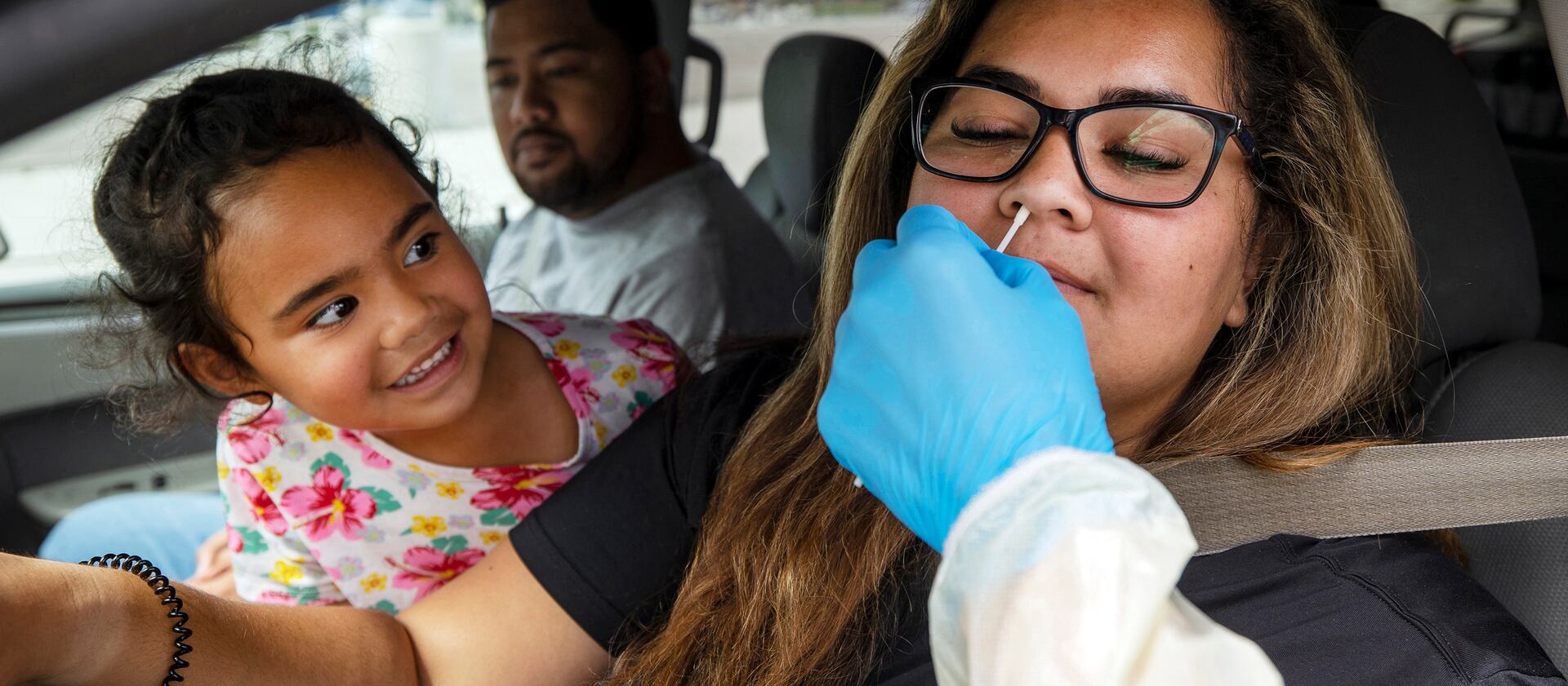 Tialani Alatini, watches as her mom Justina Alatini, receives a Rapid Antigen COVID-19 test at Rio Tinto Stadium in Sandy on Monday, Aug. 2, 2021.