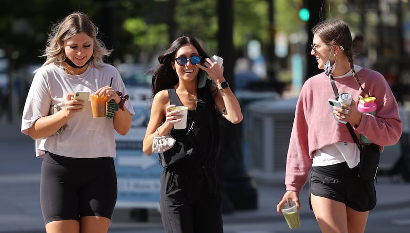 Mikayla Melchert, left, Kinzie Hague and Taylor Brockhoff go maskless in Salt Lake City on Friday, May 14, 2021.