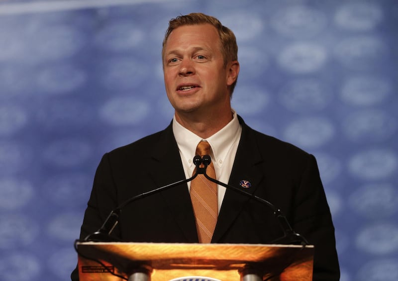 FILE - In a Thursday, July 21, 2016 file photo, Virginia head coach Bronco Mendenhall speaks during a news conference at the Atlantic Coast Conference Football Kickoff in Charlotte, N.C. Mendenhall went about installing an "earned, not given" approach at