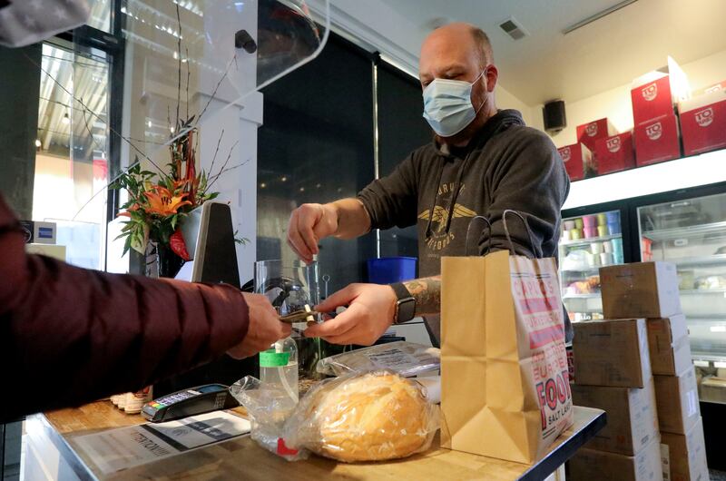 Jamey Chelius, Caputo’s Market and Deli general manager, rings a customer up at Caputo’s Market and Deli in Salt Lake City on Wednesday. Salt Lake City Mayor Erin Mendenhall announced the Shop Small Crawl to support Small Business Saturday, including the chance to win a $500 local shopping spree.