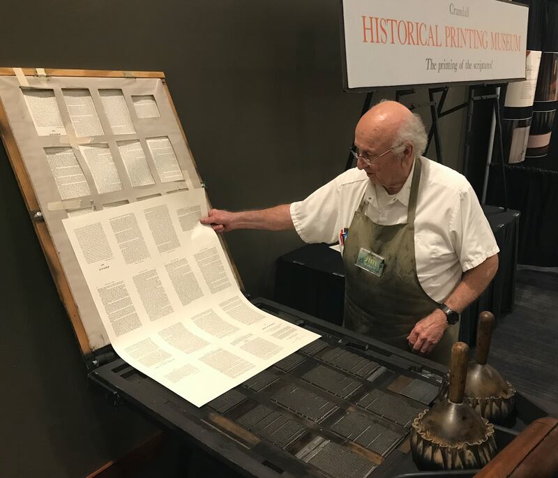 Jim Watkins demonstrates how the first copies of the Book of Mormon were printed on a replica of the E.B. Grandin printing press, from the Crandall Historical Printing Museum, at the Book of Mormon Central 2018 Conference at the Utah Valley Convention Cen