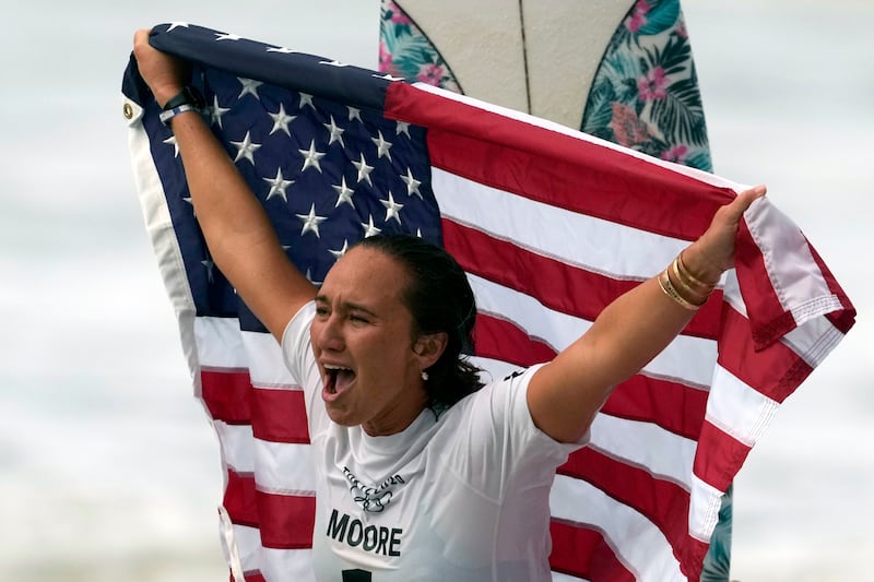 Carissa Moore of the United States celebrates winning the gold medal in surfing at the 2020 Summer Olympics.