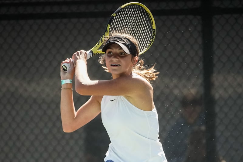Tia Christopulos, of Layton, returns the shot of Jane Dunyon, of Weber, during the 6A girls tennis state tournament at Liberty Park.