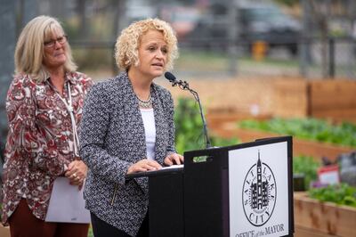 Rocky Mountain Power CEO Cindy Crane listens as Salt Lake City Mayor Jackie Biskupski helps unveil the city's newest community garden in the Gateway area on Tuesday, Oct. 9, 2018. The land the garden sits on is owned by Rocky Mountain Power.