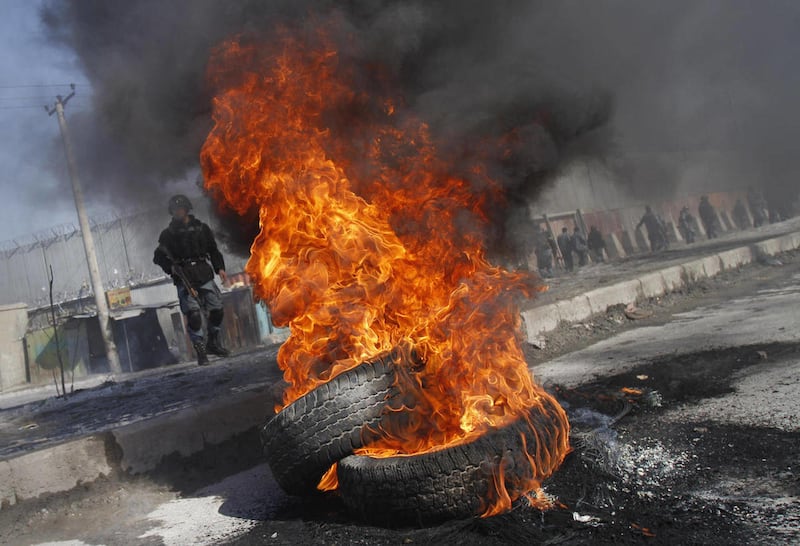 Burning tyres are seen during an anti-US demonstration in Kabul, Afghanistan, Wednesday, Feb. 22, 2012.