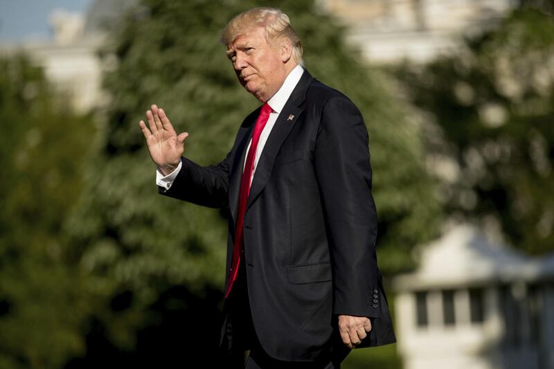 President Donald Trump walks across the South Lawn as he arrives at the White House in Washington, Friday, April 28, 2017.