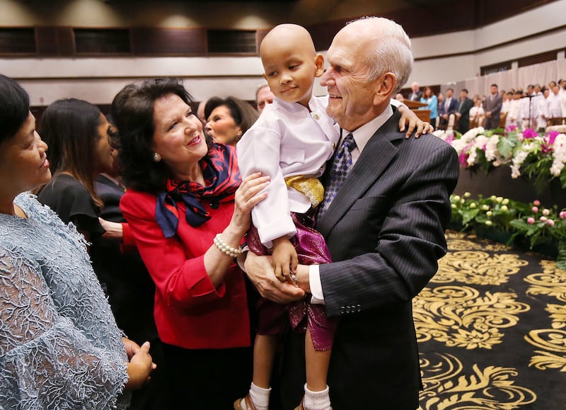 Russell M. Nelson, president of The Church of Jesus Christ of Latter-day Saints, and his wife Sister Wendy Watson Nelson, hold up Four Tanapumtonger after a devotional in Bangkok on Friday, April 20, 2018.