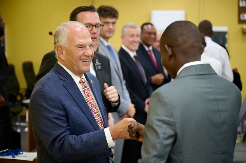 Elder Ronald A. Rasband of the Quorum of the Twelve Apostles smiles while meeting a missionary in the Democratic Republic of the Congo Missionary Training Center on Sunday, November 2, 2025.
