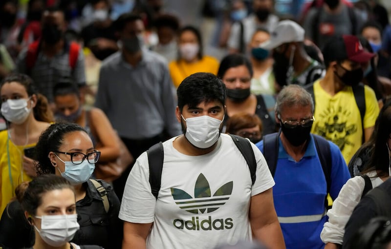 People wear protective face masks amid the COVID-19 pandemic.
