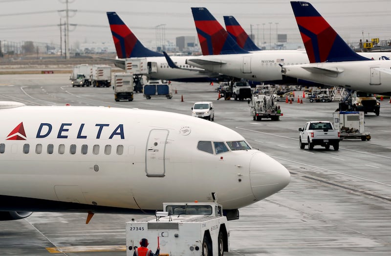 A Delta plane leaves a hangar at the Salt Lake City International Airport on Thursday, March 11, 2021.