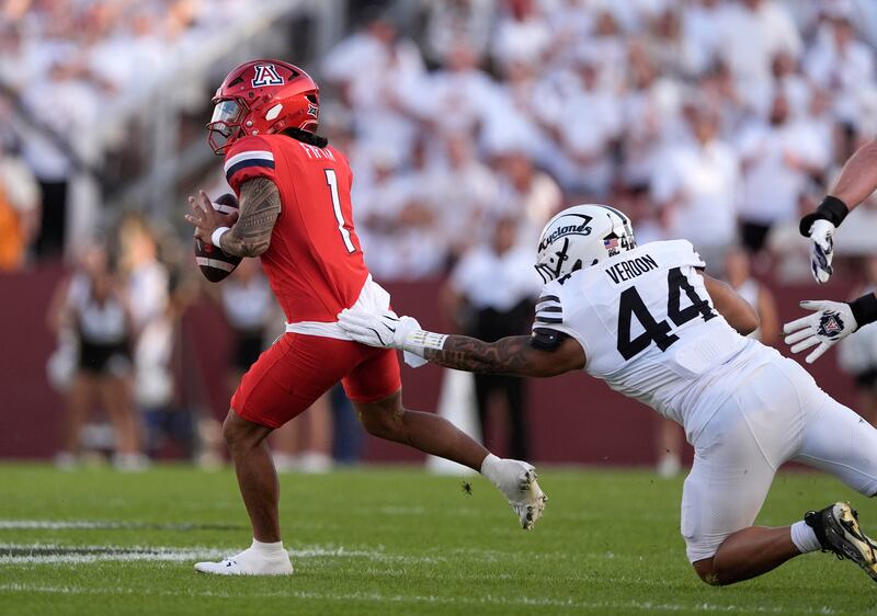 Arizona quarterback Noah Fifita (1) pulls away from Iowa State defensive lineman Trey Verdon during game, Saturday, Sept. 27, 2025, in Ames, Iowa.