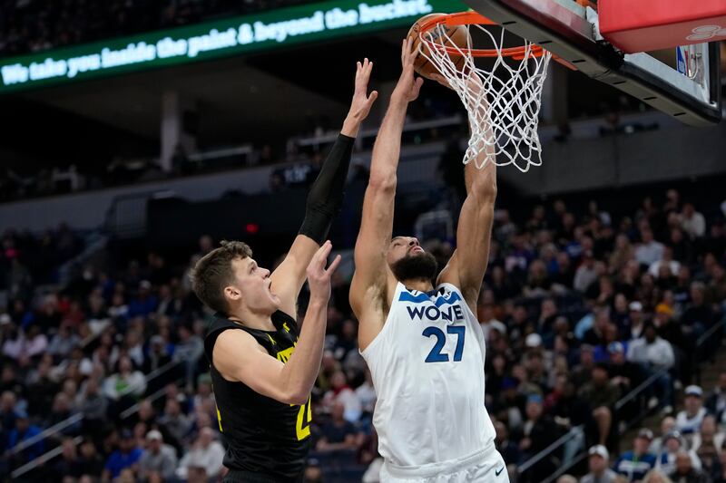 Minnesota Timberwolves center Rudy Gobert (wearing white) shoots as Utah Jazz center Walker Kessler defends