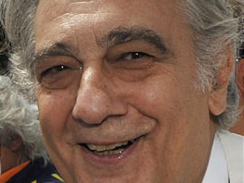 FILE - in this July 26, 2009 file photo tenor Placido Domingo pose on the grid prior to the start of the Hungarian Formula One Grand Prix at the Hungaroring circuit near Budapest, Hungary. Spokeswoman Nancy Seltzer said Monday March 8, 2010 that the 69-ye