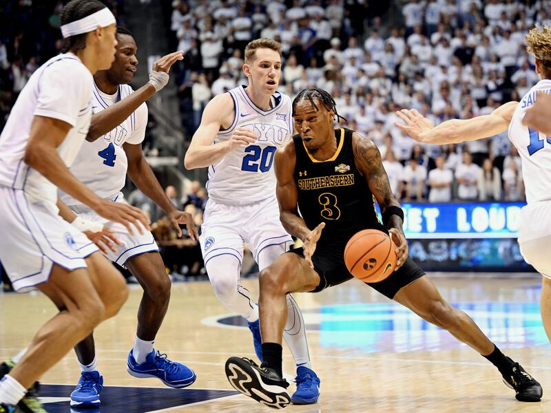 Southeastern Louisiana Lions guard Roger McFarlane (3) drives hard to the hoop with Brigham Young Cougars guard Spencer Johnson (20) Brigham Young Cougars forward Atiki Ally Atiki (4) and Brigham Young Cougars guard Trey Stewart (1) defending