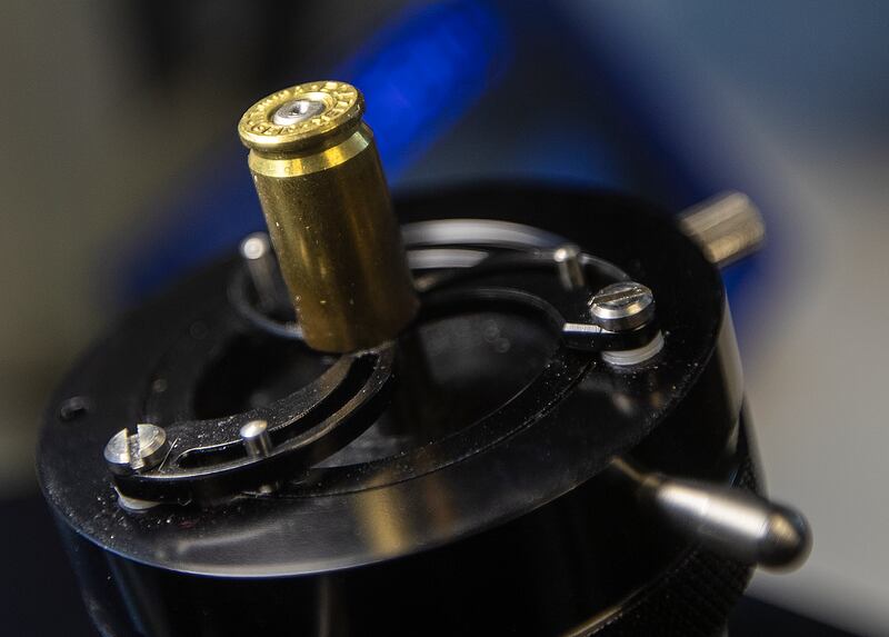 A spent shell casing sits in a holder for examination at the Utah State Crime Lab in Taylorsville on Monday, Aug. 27, 2018. Federal, state and local law enforcement leaders were at the lab to tout the National Integrated Ballistic Information Network.