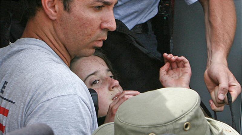 Nadia Bloom, 11, missing since Friday afternoon, is carried by rescuers after being found on Tuesday.