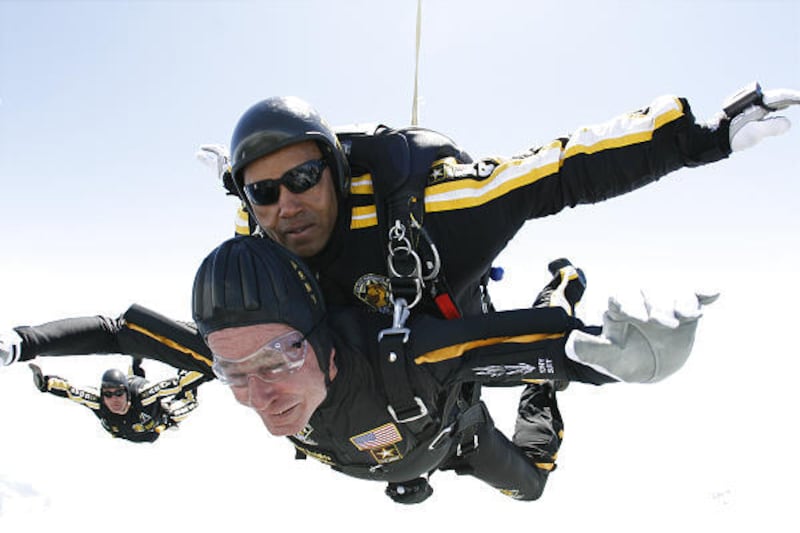 Former President George H.W. Bush, bottom, celebrates his 85th birthday by riding tandem with Sgt. Michael Elliott of the Army Golden Knights parachute team in a parachute jump Friday in Maine.