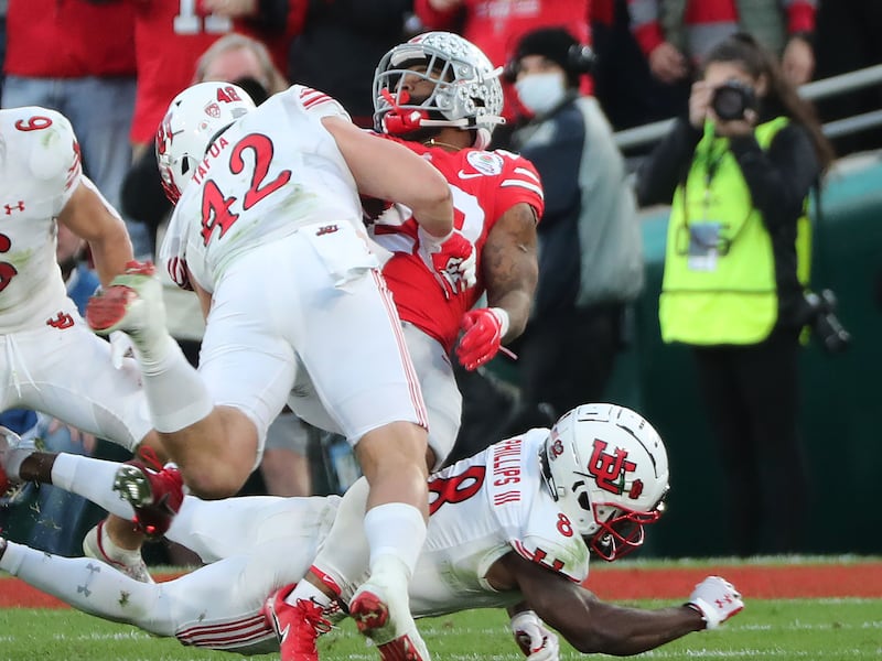 Utah defensive end Mika Tafua (42) tackles Ohio State running back Miyan Williams during the Rose Bowl in Pasadena, Calif.
