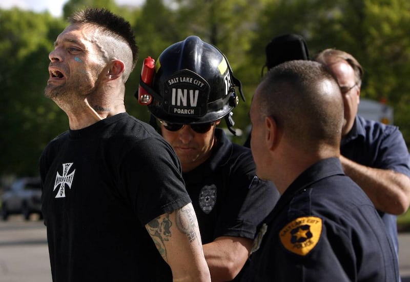 Daniel Ivins, 33, is taken into custody at a house fire at 377 W. 800 North in Salt Lake City on May 8, 2013. He was charged Wednesday with attempted murder, aggravated arson and other charges.