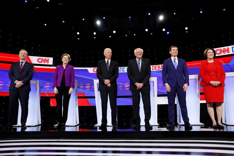 From left, Democratic presidential candidates businessman Tom Steyer, Sen. Elizabeth Warren, D-Mass., former Vice President Joe Biden, Sen. Bernie Sanders, I-Vt., former South Bend Mayor Pete Buttigieg, and Sen. Amy Klobuchar, D-Minn., stand onstage, Tuesday, Jan. 14, 2020, before a Democratic presidential primary debate hosted by CNN and the Des Moines Register in Des Moines, Iowa.