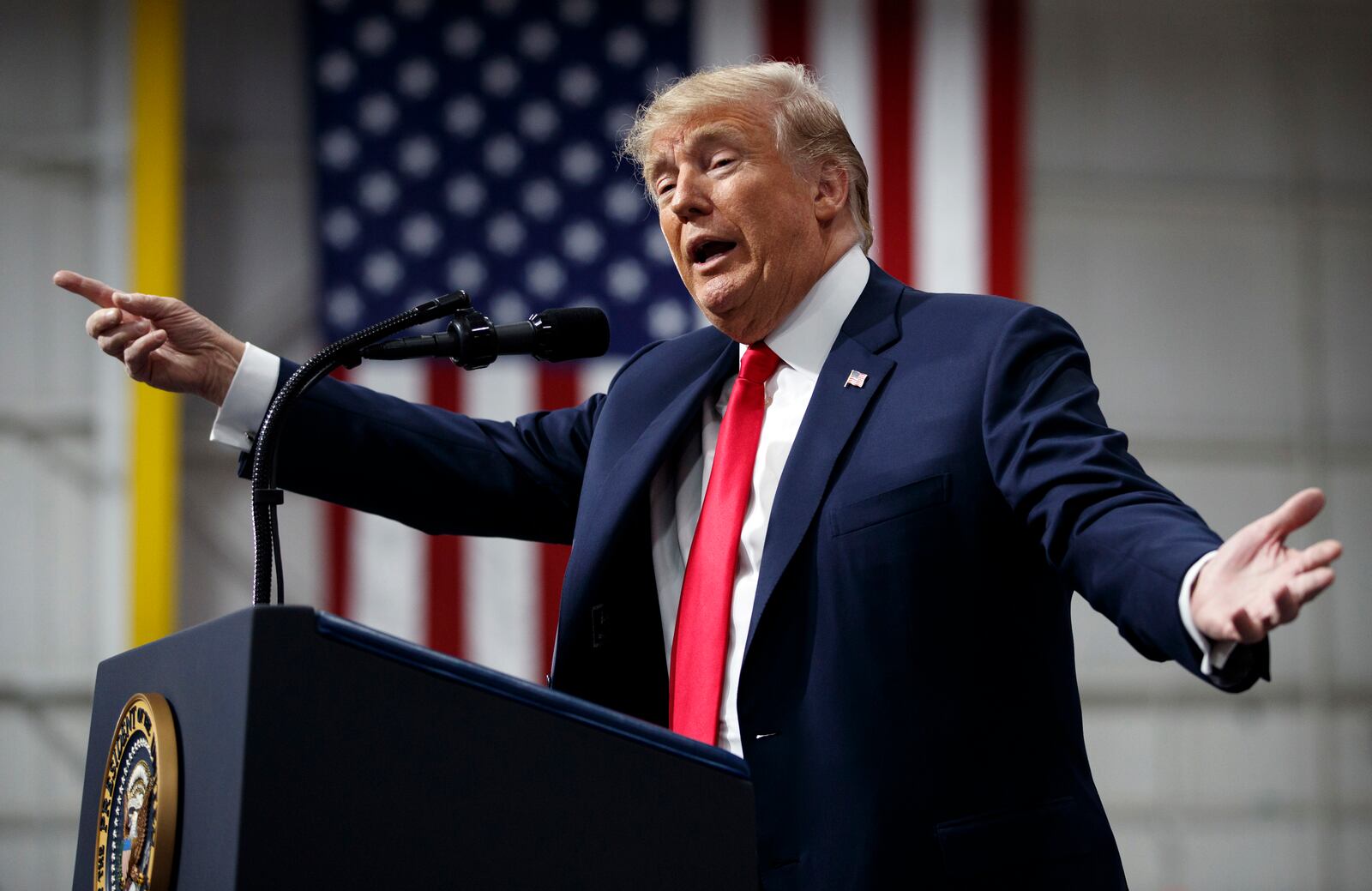 In this March 10, 2018, photo, President Donald Trump speaks at a campaign rally at Atlantic Aviation in Moon Township, Pa. Weeks after prodding lawmakers to stand up to the National Rifle Association,Trump is backing off his call for increasing the minim