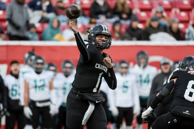 Corner Canyon quarterback Isaac Wilson throws during a 6A football semifinal game against Farmington.