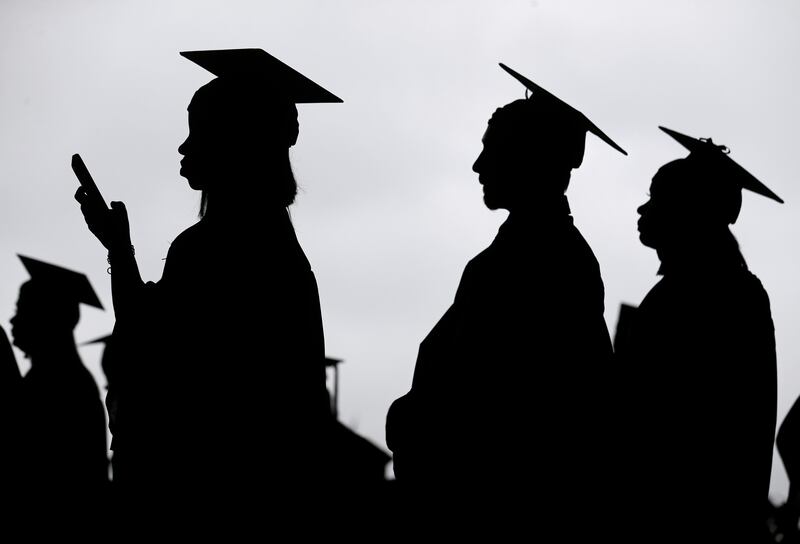 New graduates line up before the start of a community college commencement in East Rutherford, N.J.