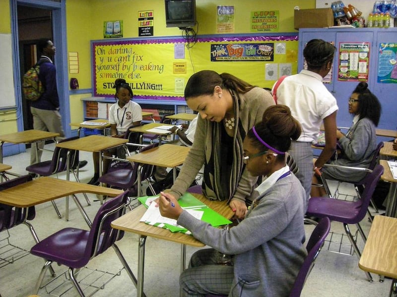 Lauren LeDuff works with a student in her 10th-grade English class at Warren Easton Charter High School in New Orleans.