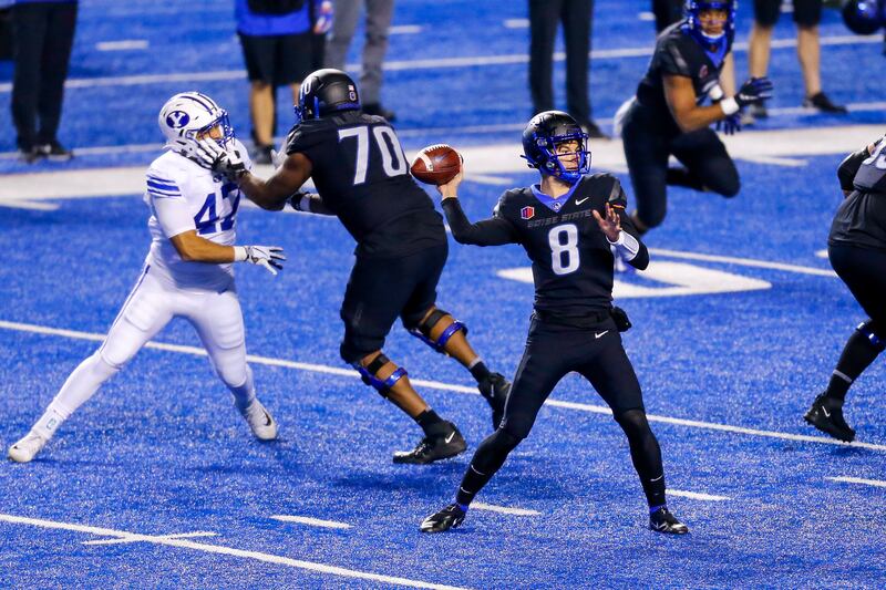 Boise State quarterback Cade Fennegan (8) throws the ball against the BYU defense.