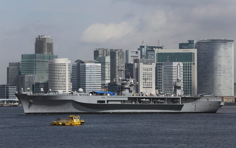 The USS Blue Ridge passes buildings on the Tokyo skyline as it sails through Tokyo Bay after a two-day port visit, Wednesday, Sept. 4, 2013. The Blue Ridge, the flagship of the U.S. 7th Fleet, made a two-day visit at the end of an Asian tour, before retu