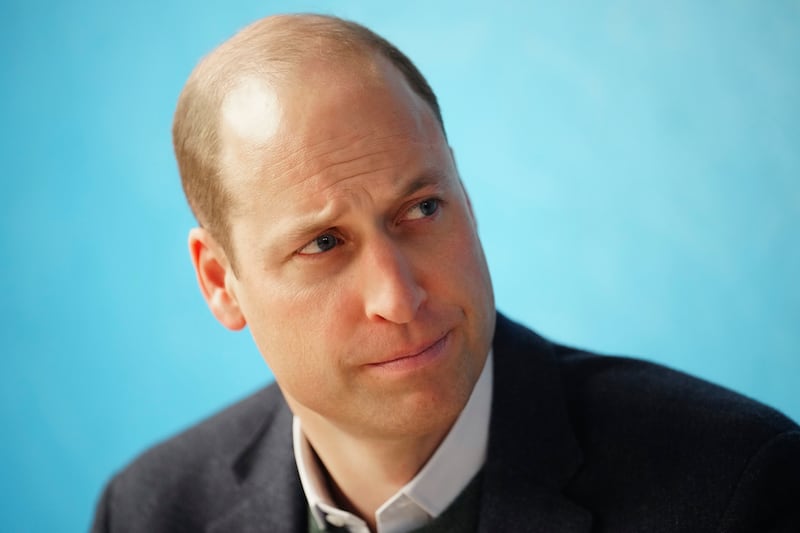 Prince William listens to staff during a visit to the Open Door Charity in Birkenhead, England.