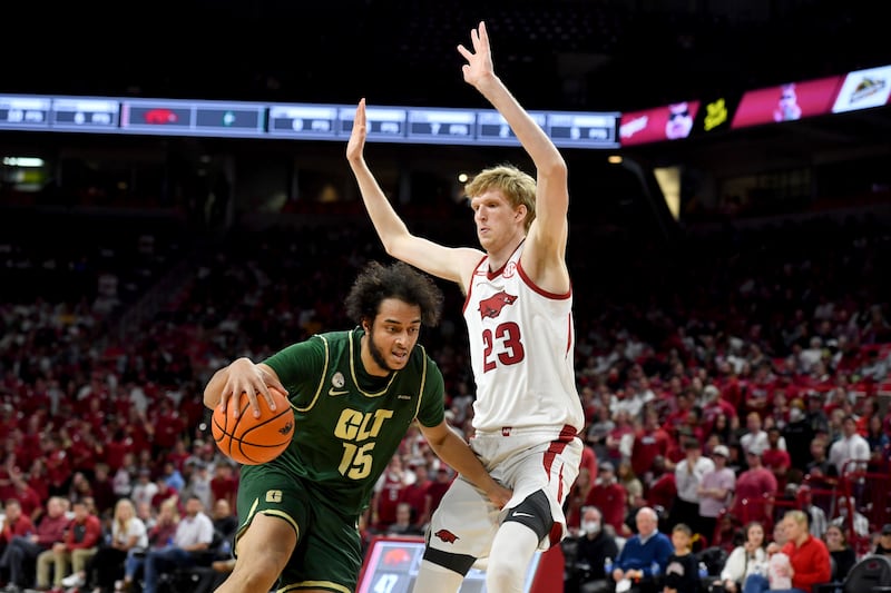Charlotte forward Aly Khalifa (15) tries to get past Arkansas forward Connor Vanover during an NCAA college basketball game.