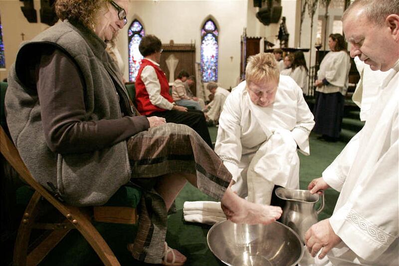 Rev. Rick Lawson, right, and Caryl Marsh, center, wash Carole Merril's feet during Maundy Thursday mass at St. Mark's Cathedral in Salt Lake City in 2008.
