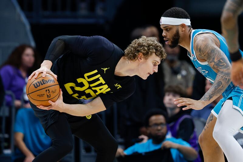 Utah Jazz forward Lauri Markkanen, left, looks to drive against Charlotte Hornets forward Miles Bridges during the second half of an NBA basketball game in Charlotte, N.C., Saturday, Jan. 27, 2024. (AP Photo/Nell Redmond)