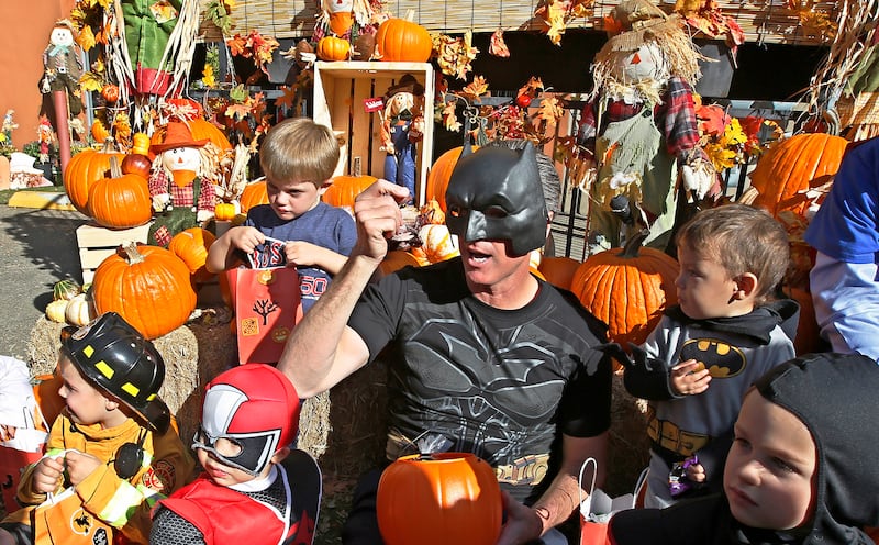 In this Oct. 31, 2018 file photo, then-Lt. Gov. Gavin Newsom, dressed as Batman, gets into the Halloween spirit as he hands out Halloween treats to costumed children during his visit to The Penleigh Child Development Center in Sacramento, Calif.