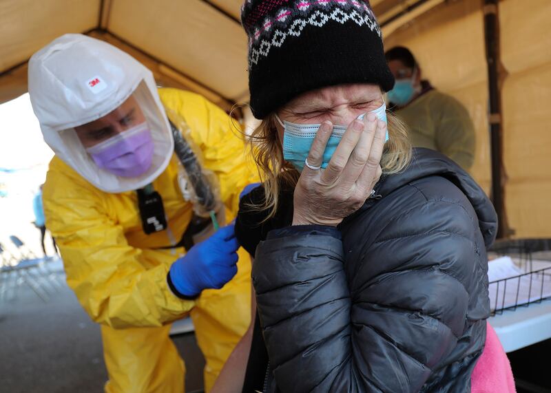 Lori Tonge grimaces as she gets a flu shot in Salt Lake City on Tuesday, Nov. 24, 2020.