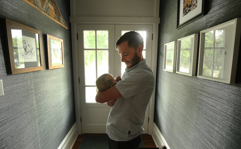 Dr. Adam Bress holds his 8-week-old son, Devan, at their home in Salt Lake City, Utah, on Wednesday, June 12, 2019.
