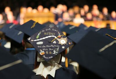 A graduate adorns her cap during Brigham Young University summer commencement in Provo on Thursday, Aug. 16, 2018.