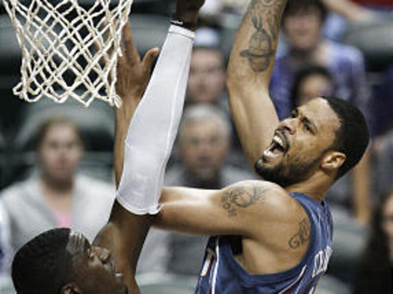 Charlotte Bobcats center Tyson Chandler, right, puts up a shot over Indiana Pacers center Roy Hibbert.
