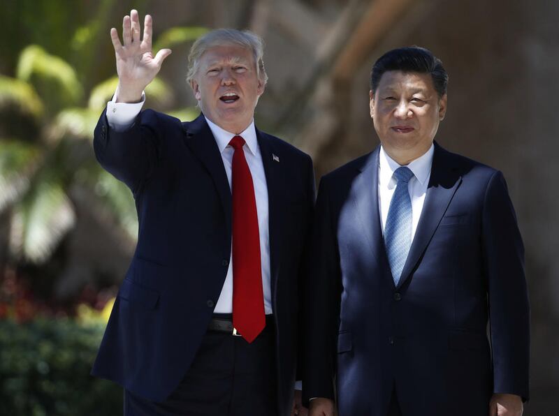 FILE - In this Friday, April 7, 2017 file photo, President Donald Trump and Chinese President Xi Jinping pause for photographs at Mar-a-Lago in Palm Beach, Fla. The United States and China struck what appeared to be an unusual bargain Wednesday as Preside