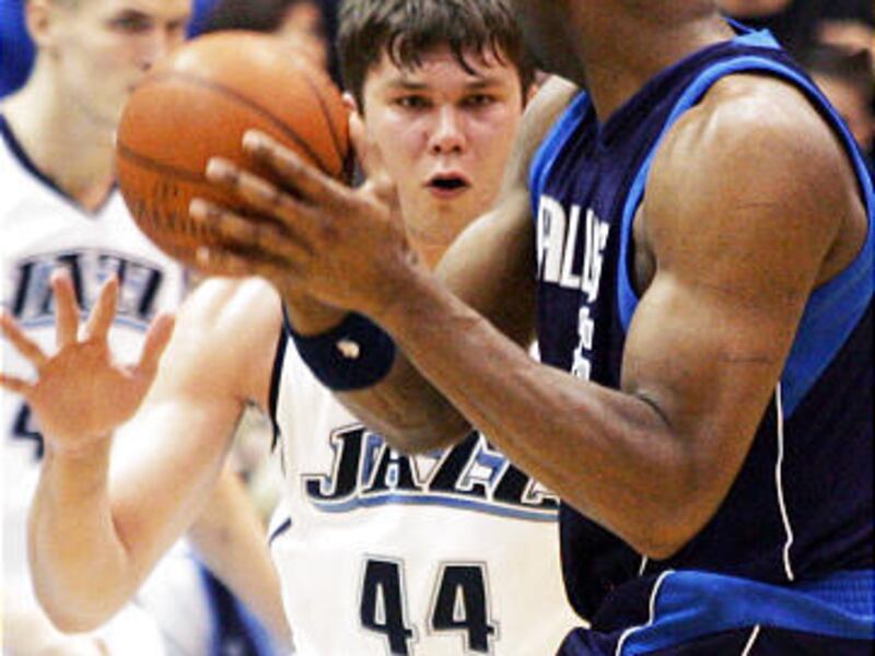 Utah center Kyrylo Fesenko intensely defends Dallas Mavericks center Erick Dampier during Friday's home victory for the Jazz.