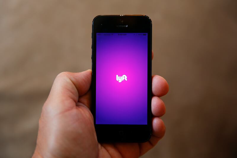 FILE - This Monday, May 16, 2016, file photo shows a smartphone displaying the Lyft app, in Detroit. The Larry H. Miller Group, owner of the Salt Lake Bees, announced a new partnership with ridesharing service Lyft for home game transport options.