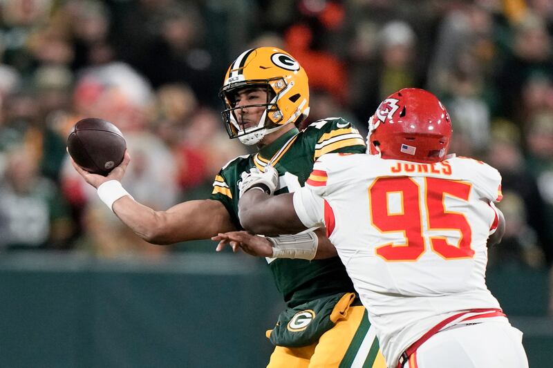 Green Bay Packers quarterback Jordan Love (10) throws under pressure from Kansas City Chiefs defensive tackle Chris Jones (95) during the first half of an NFL football game Sunday, Dec. 3, 2023 in Green Bay, Wis.