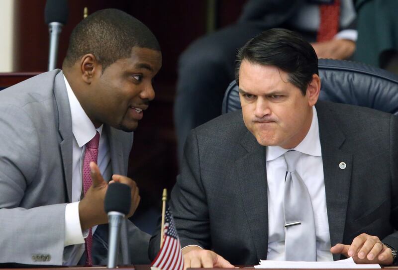 FILE - In this March 9, 2017, file photo, Rep. Byron Donalds, R-Naples, left, confers with Rep. Cord Byrd, R-Neptune Beach, in Tallahassee, Fla. Donalds is the lead sponsor of a proposal that would allow parents whose children have been bullied at public