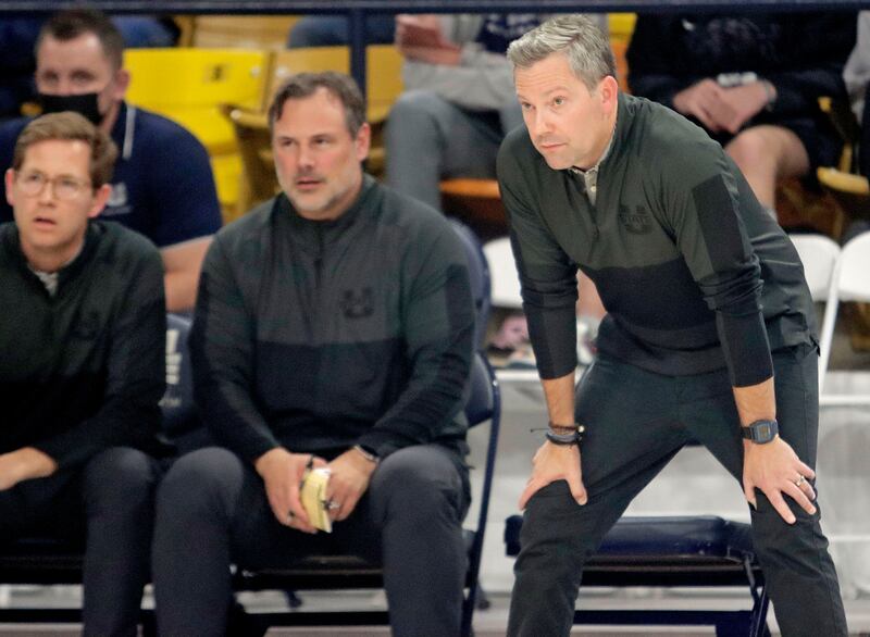 New USU head coach Ryan Odom, right, brought along nearly his entire staff from UMBC, including assistant coaches.