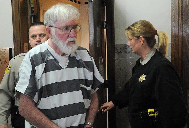 FILE - In this Feb. 2, 2012, file photo Carl Ericsson is escorted into court in Madison, S.D. The 73-year-old South Dakota man accused of fatally shooting his long-ago classmate will plead guilty but mentally ill to a second-degree murder charge, his att