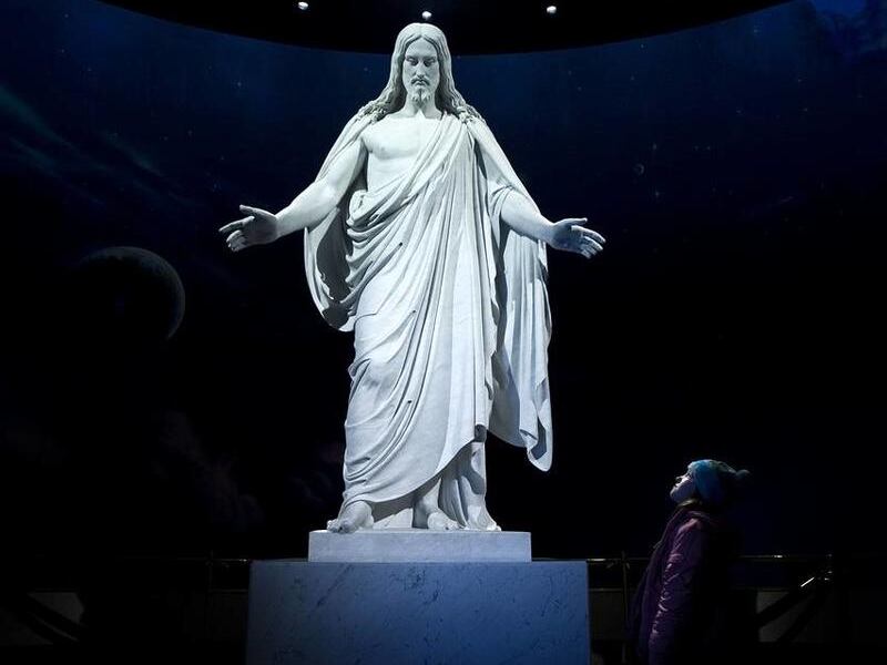 A young girl looks up at the Christus statue in the visitors center on Temple Square of The Church of Jesus Christ of Latter-day Saints in 2008.