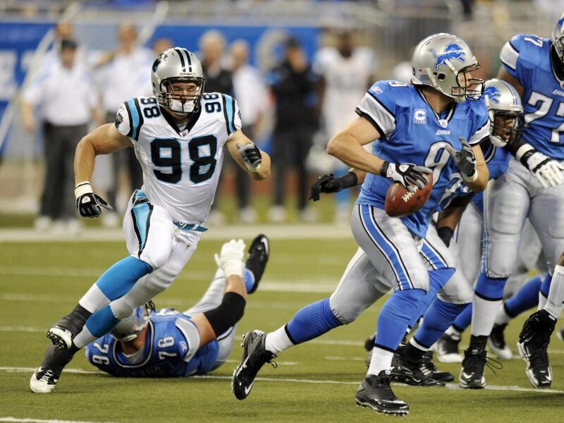 In this photo taken Nov. 20, 2011, Carolina Panthers defensive end Thomas Keiser (98) chases Detroit Lions quarterback Matthew Stafford (9) during their NFL football game at Ford Field in Detroit. Keiser left Stanford a year early certain he'd get drafte