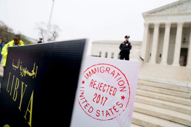 Poster sized enlargements of passports marked as "rejected" by United States Immigration are on display during an anti-Muslim ban rally as the Supreme Court hears arguments about wether President Donald Trump's ban on travelers from several mostly Muslim